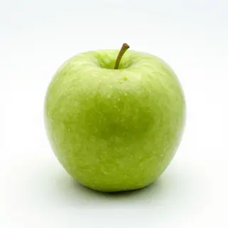 A ripe green apple on a seamless white background with soft 