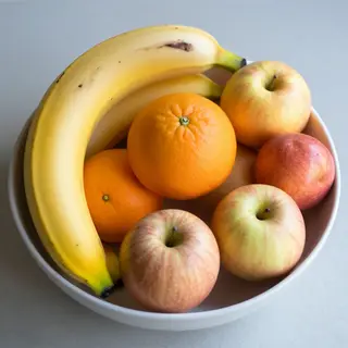 A fruit bowl containing exactly 3 bananas, 4 oranges, and 2 