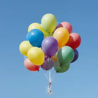 Exactly 11 colorful balloons floating against a clear blue s