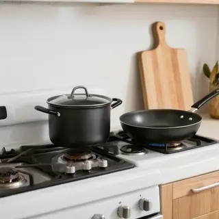 A kitchen with pots, pans, a stove, and a cutting board but 