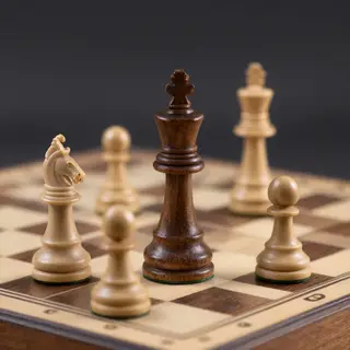 Five chess pieces on a board: a king in the center, a queen 