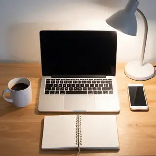 A desk scene: laptop in the center, coffee mug to the left, 