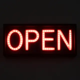 The word 'OPEN' displayed on a red LED sign with glowing pix