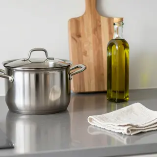A kitchen counter with a stainless steel pot, a wooden cutti