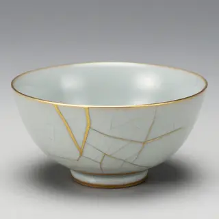 A Japanese kintsugi bowl — cracked ceramic repaired with vis