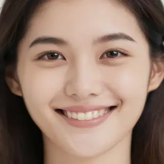 A close-up portrait of a young woman with a warm natural smi