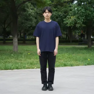 A person standing in a neutral pose in a park, full body vis