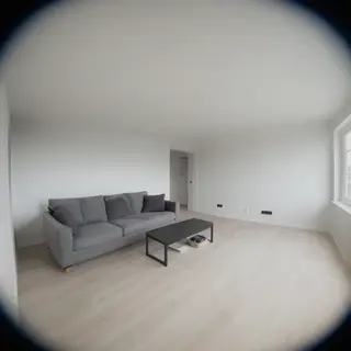 A wide-angle shot of a modern living room interior showing e