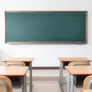 A classroom with desks and a chalkboard but no students