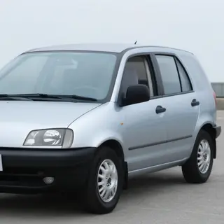 A car body with windows, doors, and headlights but no wheels