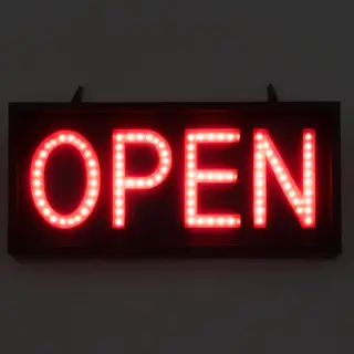 The word 'OPEN' displayed on a red LED sign with glowing pix