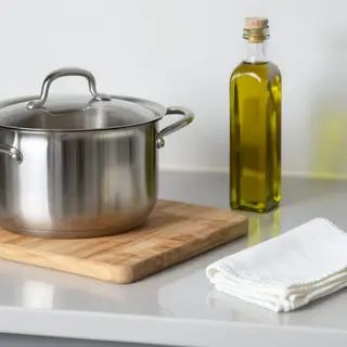 A kitchen counter with a stainless steel pot, a wooden cutti