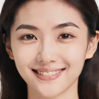 A close-up portrait of a young woman with a warm natural smi