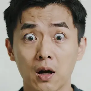 A portrait capturing genuine surprise — raised eyebrows, wid