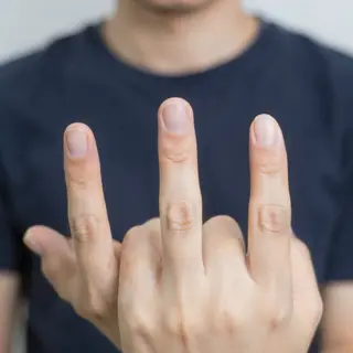 A person counting to three on their fingers, with index, mid
