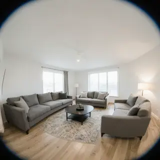A wide-angle shot of a modern living room interior showing e