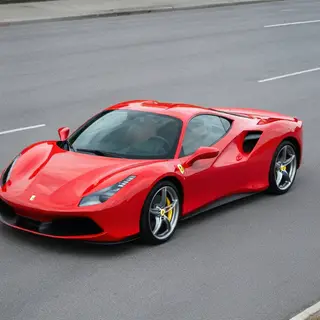 A bright red sports car parked on a gray asphalt road — the 