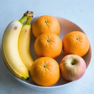 A fruit bowl containing exactly 3 bananas, 4 oranges, and 2 