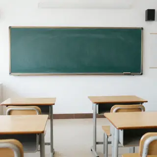 A classroom with desks and a chalkboard but no students