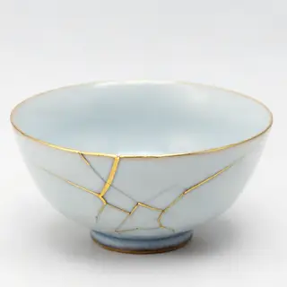 A Japanese kintsugi bowl — cracked ceramic repaired with vis