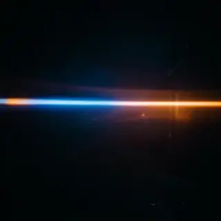 A cinematic frame with blue and orange anamorphic lens flare