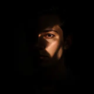 A portrait lit with classic Rembrandt lighting — triangle of