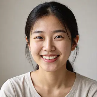 A close-up portrait of a young woman with a warm natural smi