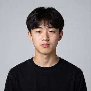 A headshot of a teenager with a relaxed, neutral face