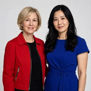 Two women standing side by side: one with short blonde hair 