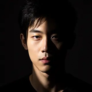 A portrait with dramatic split lighting — half the face brig