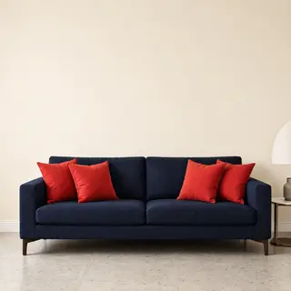 A minimalist room with walls in #F5E6CC (warm cream), a sofa
