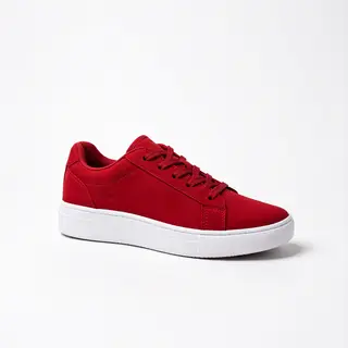 A single red sneaker on a clean white background with soft s