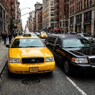 A yellow taxi and a black limousine parked next to each othe