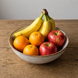 A fruit bowl containing exactly 3 bananas, 4 oranges, and 2 