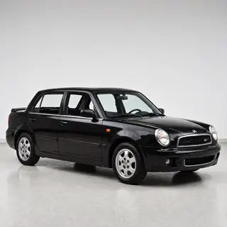 A car body with windows, doors, and headlights but no wheels