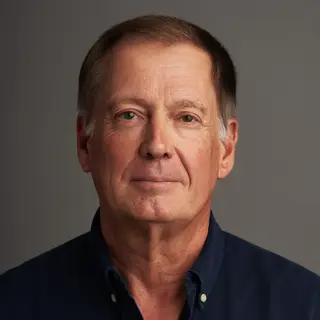 A portrait of a middle-aged man with a calm, serious express