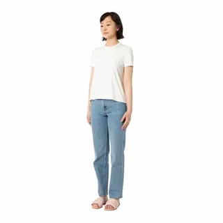 A woman standing upright in a relaxed pose, arms at her side