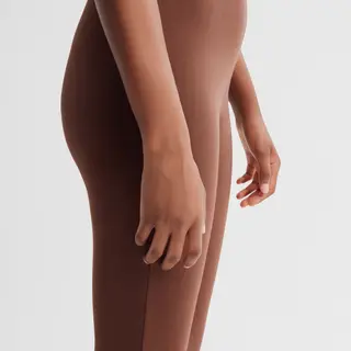 A person standing with both hands visible at their sides, fi