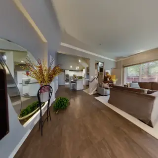A wide-angle shot of a modern living room interior showing e