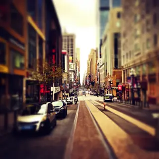 A tilt-shift photograph of a city street making real-life lo
