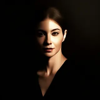 A portrait with dramatic split lighting — half the face brig