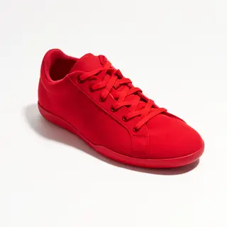 A single red sneaker on a clean white background with soft s