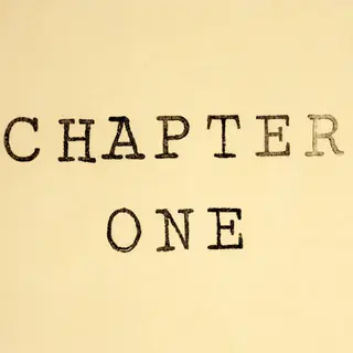 The word 'CHAPTER ONE' typed on aged paper with a vintage ty