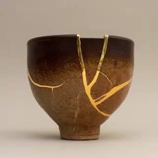 A Japanese kintsugi bowl — cracked ceramic repaired with vis