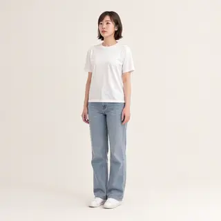A woman standing upright in a relaxed pose, arms at her side