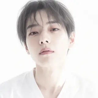 A high-key portrait of a person against a bright white backg