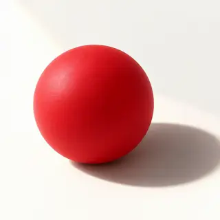 A red sphere on a white surface with a single shadow cast to