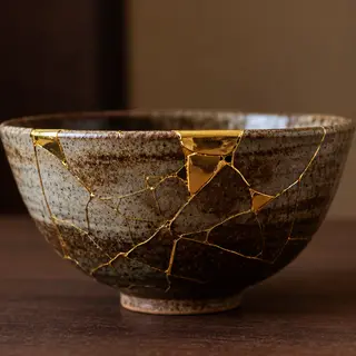 A Japanese kintsugi bowl — cracked ceramic repaired with vis