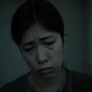 A face showing quiet melancholy — downcast eyes, slightly dr