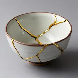 A Japanese kintsugi bowl — cracked ceramic repaired with vis